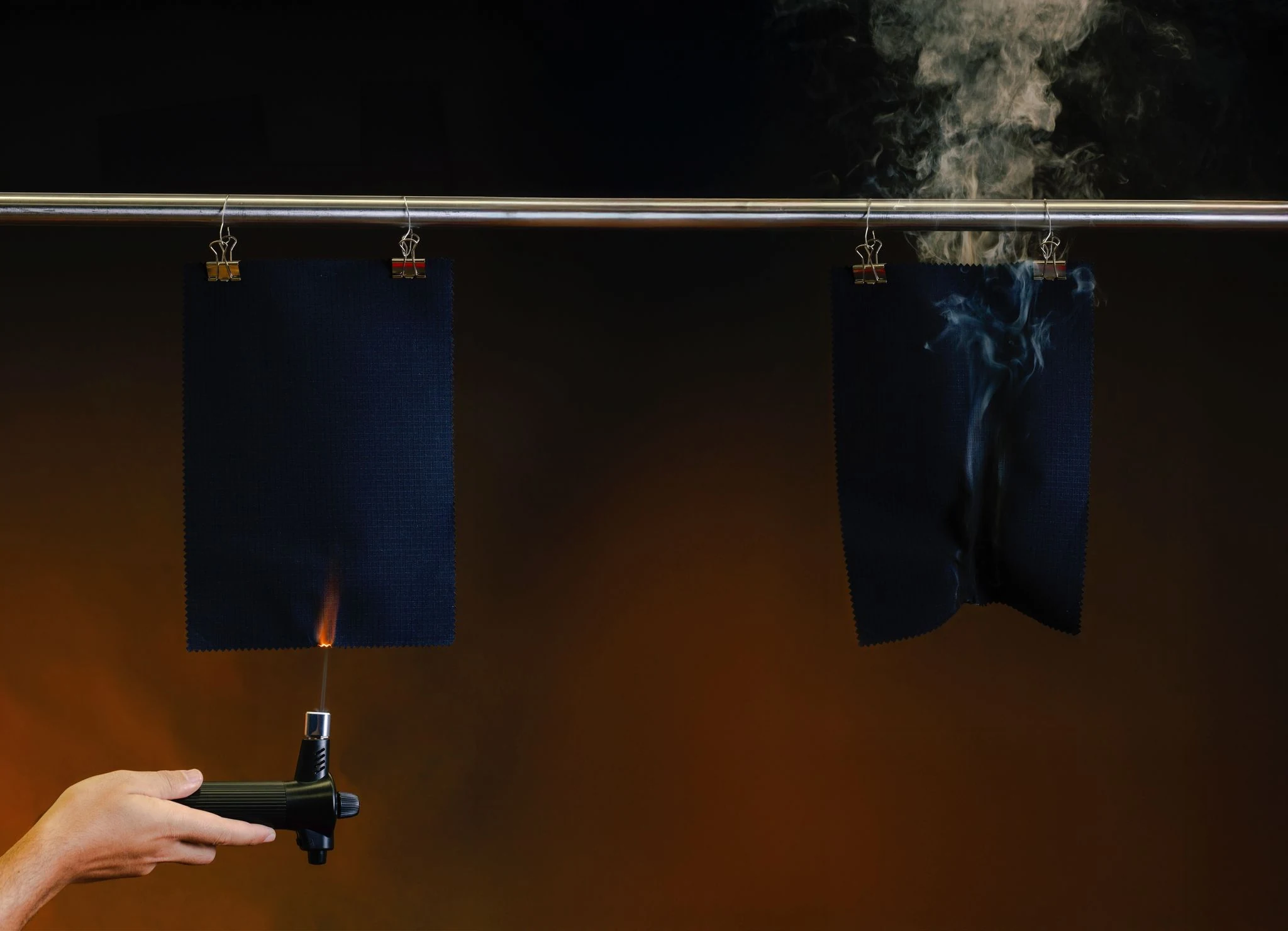 Flame resistance test comparing two fabric samples at Marina Technical Textiles