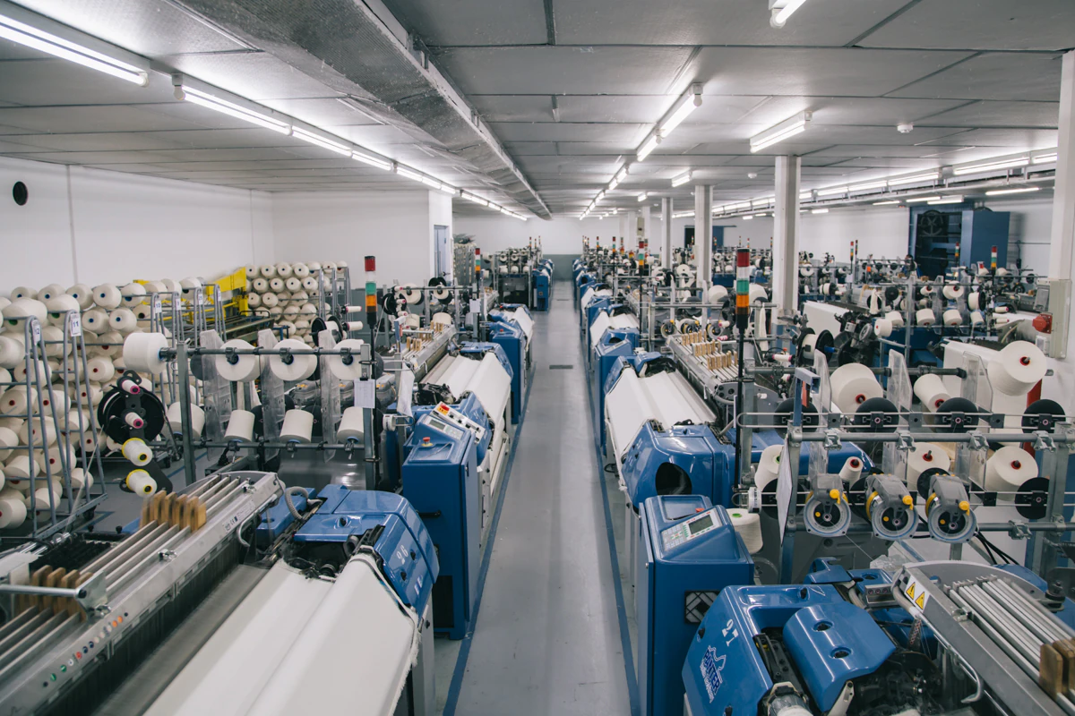 Marina weaving facility with rows of industrial looms